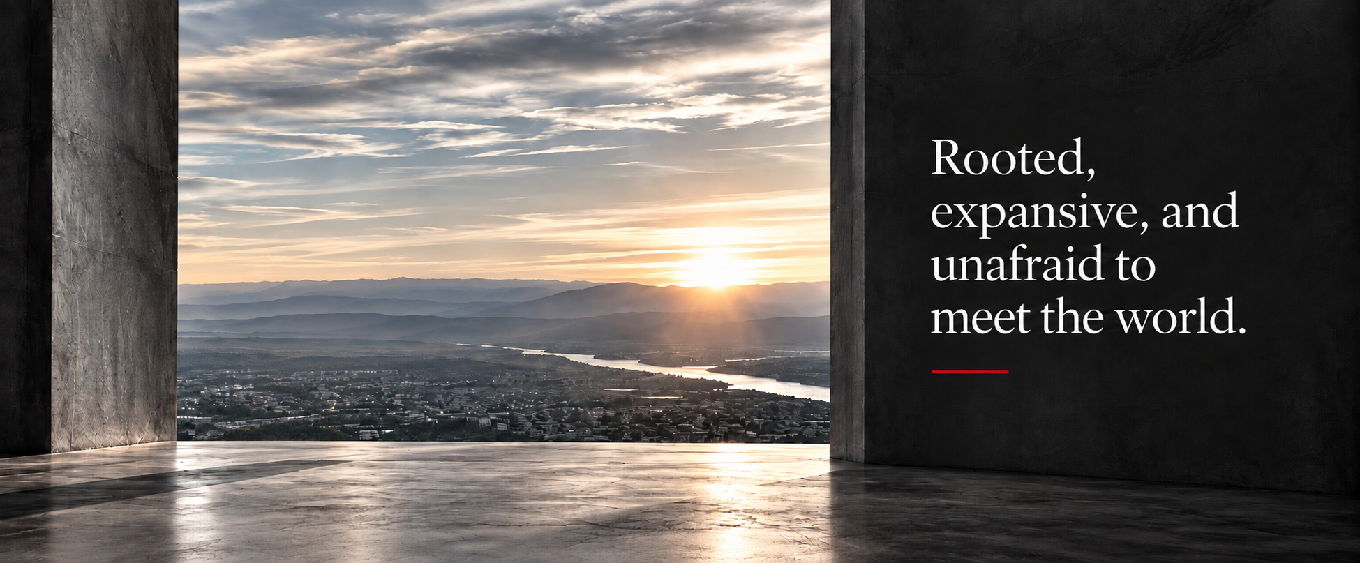 Rooted, expansive, and unafraid to meet the world — a woman in red stands in a concrete frame overlooking a vast valley at sunrise.